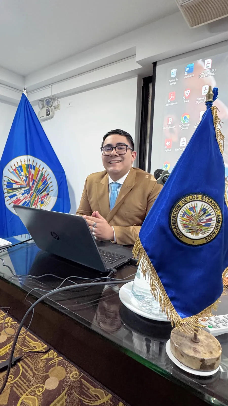 A meeting beside the flags of the Organization of American States